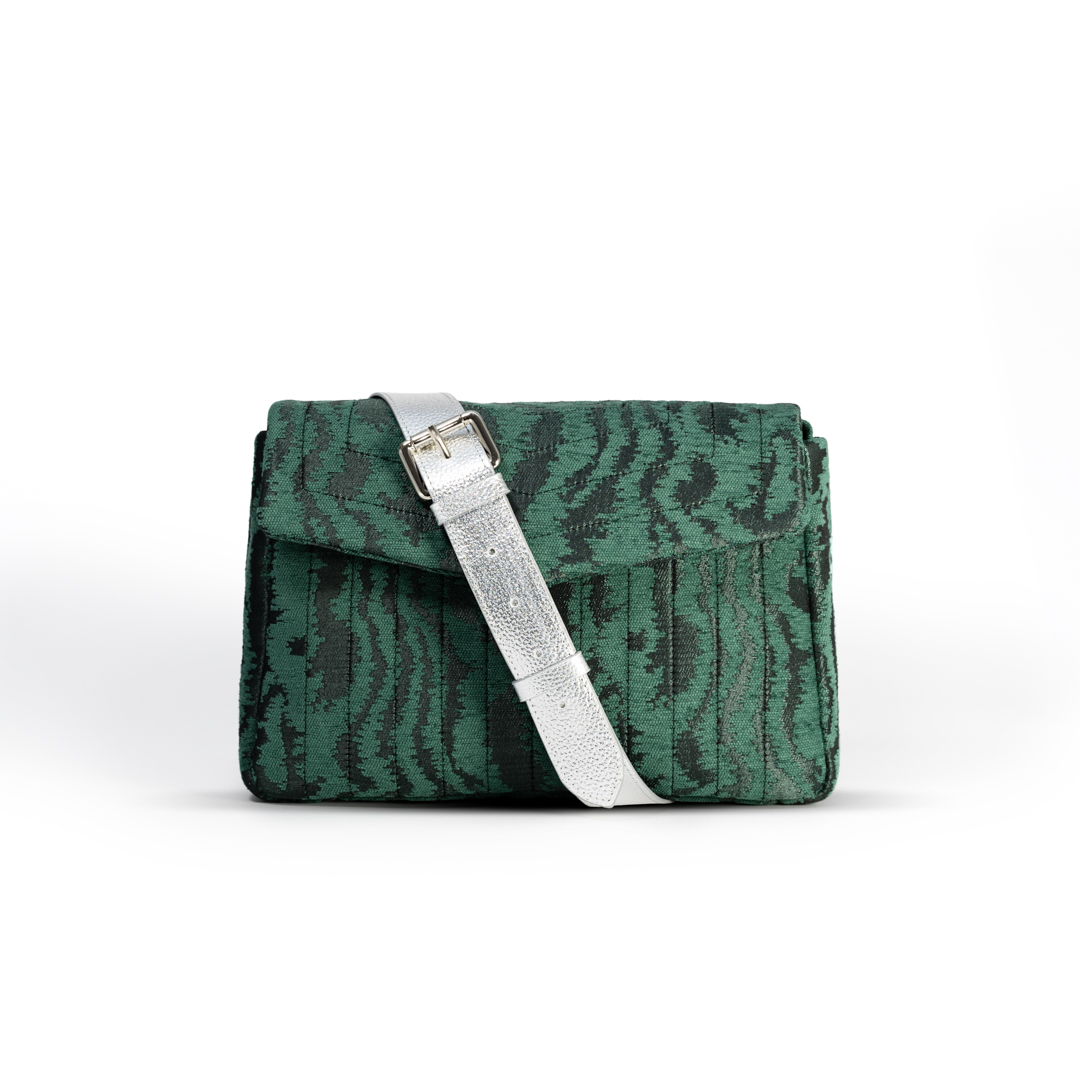 Front view of the Jade Melon crossbody bag in green moiré jacquard with a silver leather strap