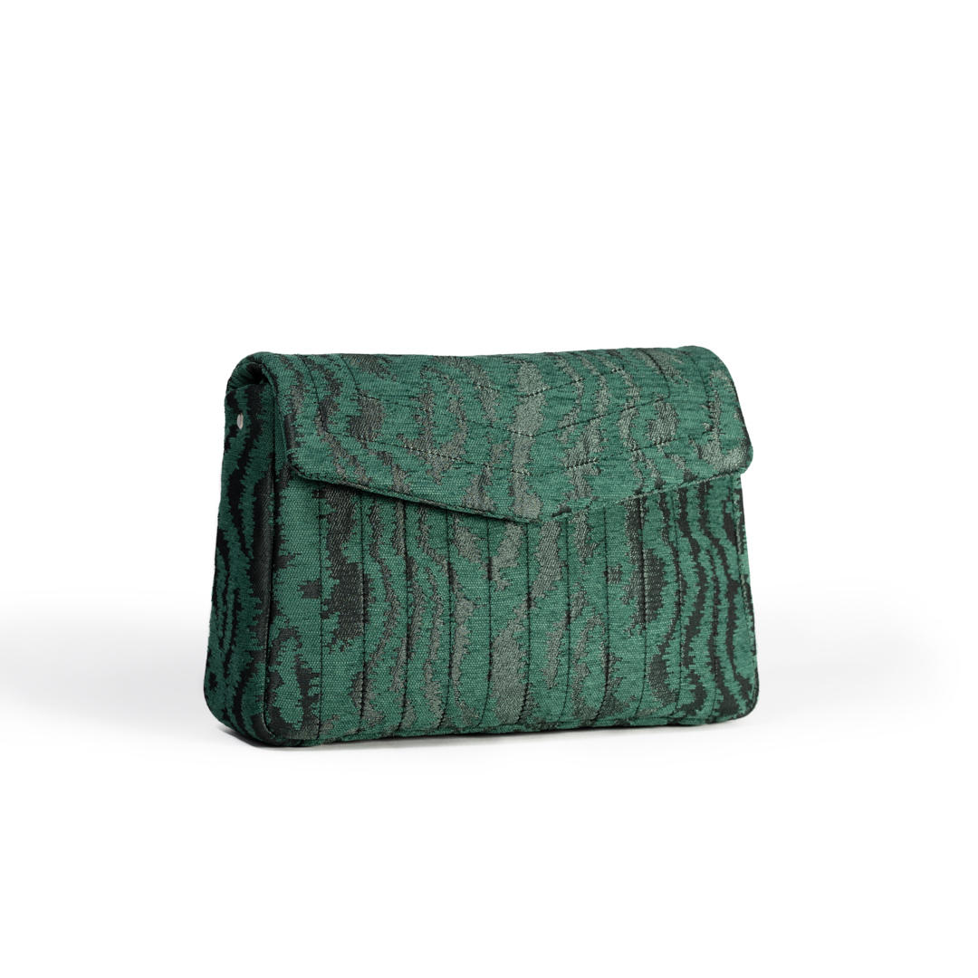 Angled side view of the Jade Melon crossbody bag with green moiré jacquard fabric and silver leather strap.
