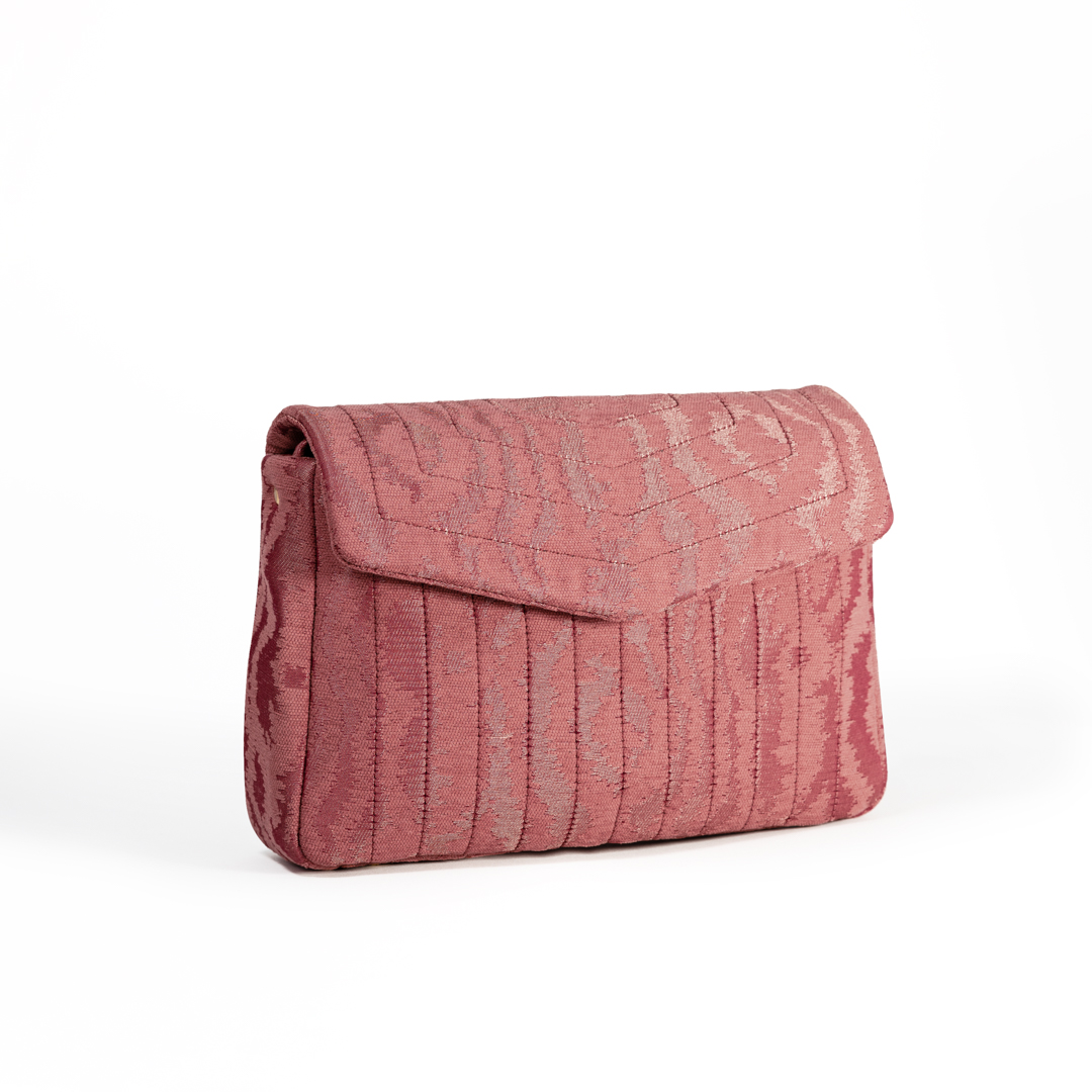 Angled side view of the Ballet Blush crossbody bag with pink moiré jacquard fabric.