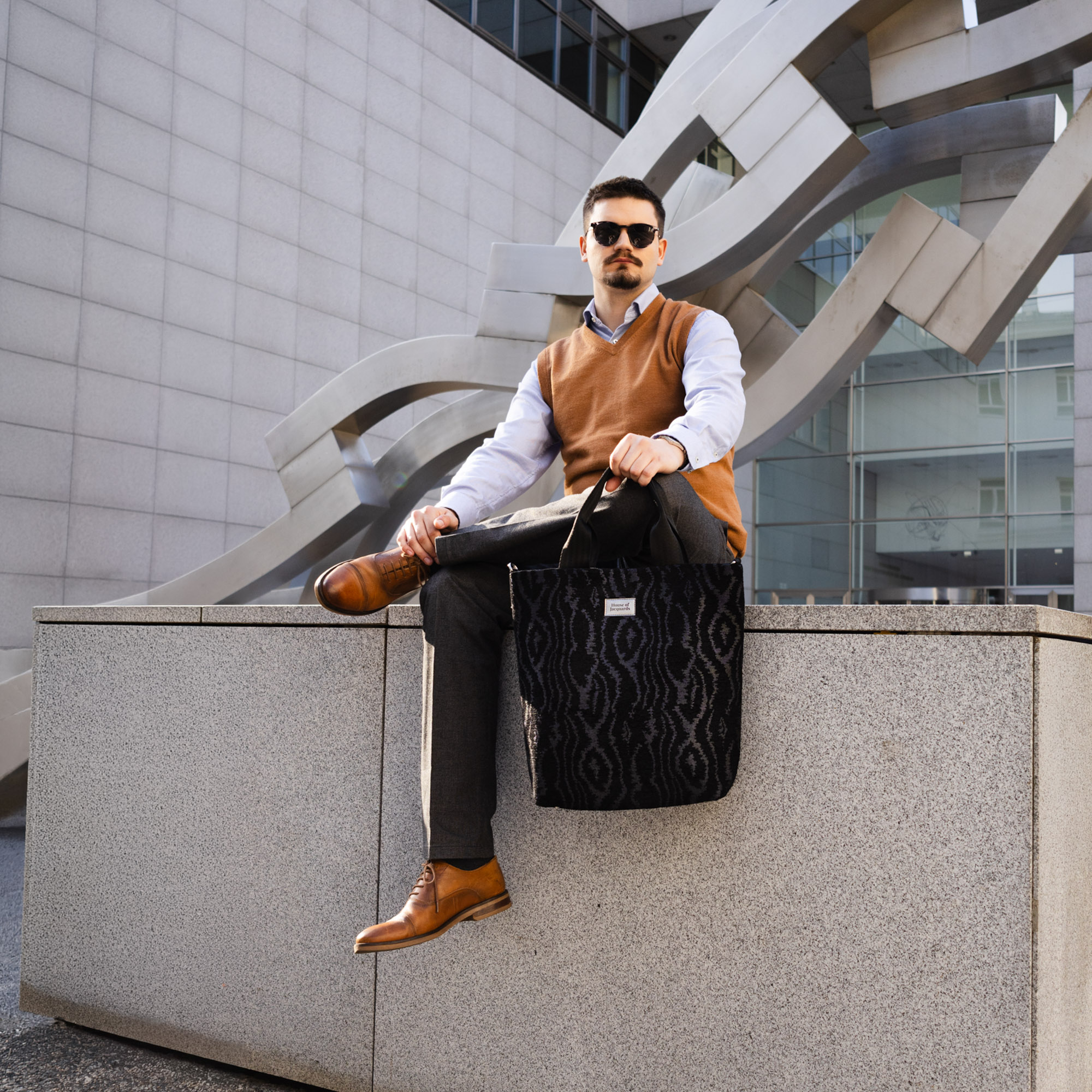 Man carrying the Eleanor Velvet Noir black jacquard business tote bag